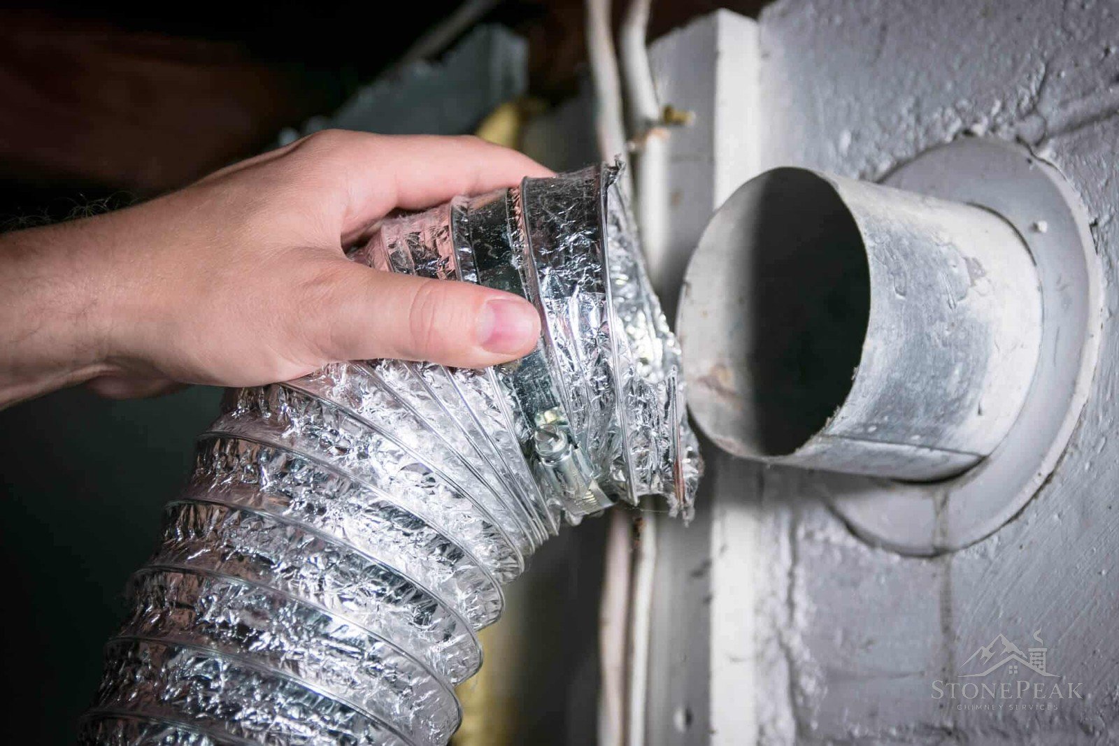 Technician connecting a dryer vent duct